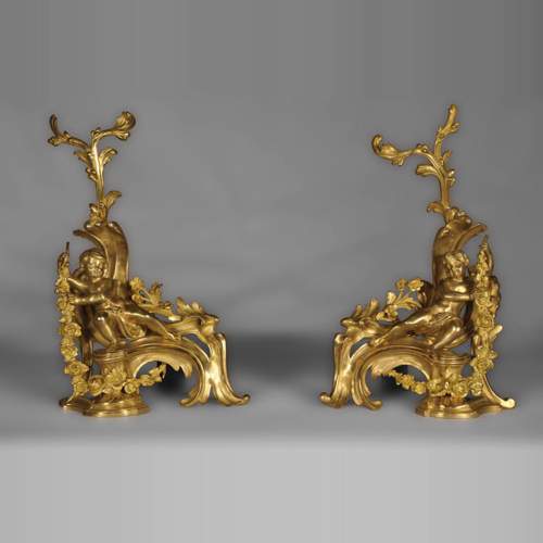 Antique Louis XV style andirons made out of gilded bronze with putti decor