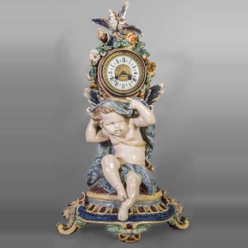 Polychrome earthenware pendulum, Cupid supporting the dial