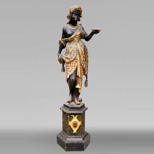 Polychrome carved and gilded wood Nubian torch-holder