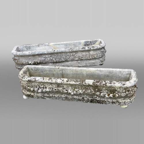 Pair of rectangular stone planters, decorated with floral scrollwork.