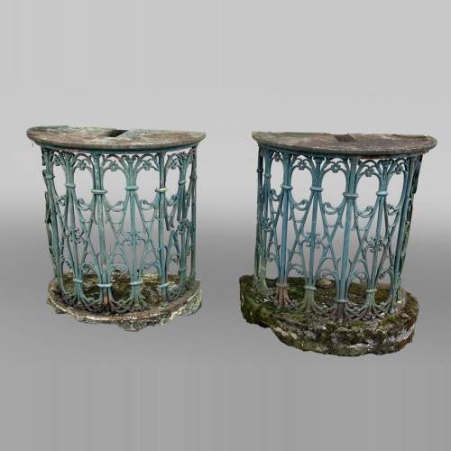 Pair of wrought-iron outdoor side-tables, half-moon shape