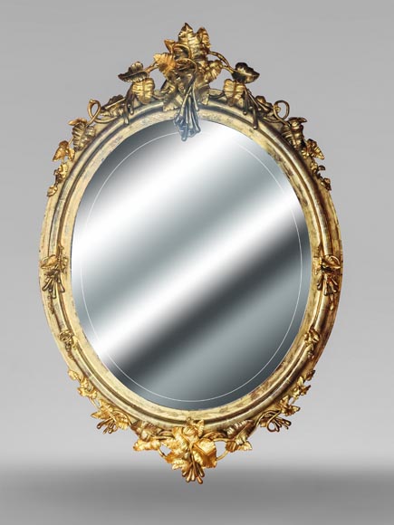 Oval gilt mirror in the Napoleon III style, featuring rich foliate ornamentation Oval gilt mirror in the Napoleon III style, featuring rich foliate ornamentation-0