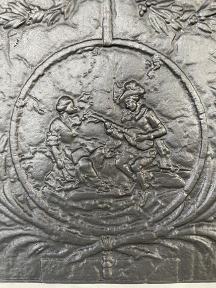 Fireback adorned with a romantic scene in a medallion-1