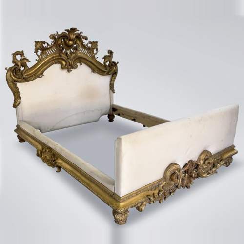 Gilt and sculpted wood bed with a very rich Rococo decoration and dragons coming from Marlène Dietrich's Parisian appartment