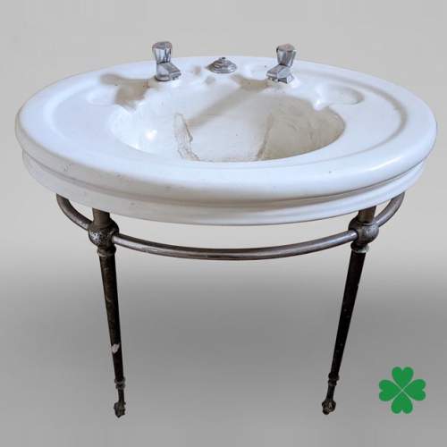 Earthenware washbasin on a chromium foot with lion paws