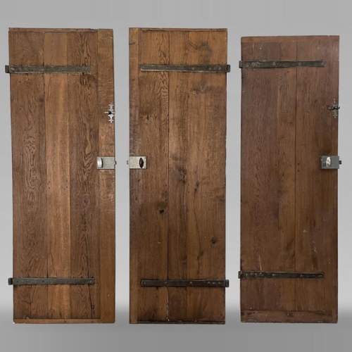 Series of three antique oak doors with their metal hinge