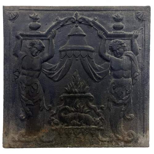 Fireback of the 18th century with two atlantes supporting an entablature with fire vases