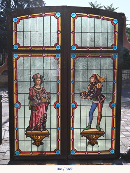 Double stained glass window in neo-Renaissance style depicting two figures with offerings-8