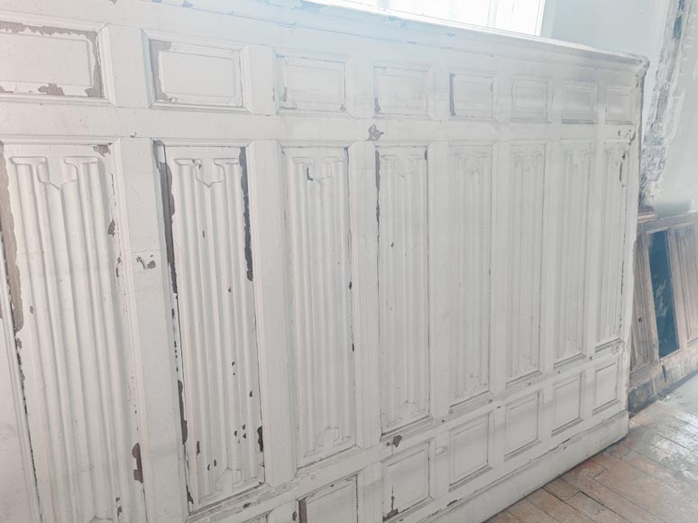 Neo-Gothic style oak wainscoting featuring a 