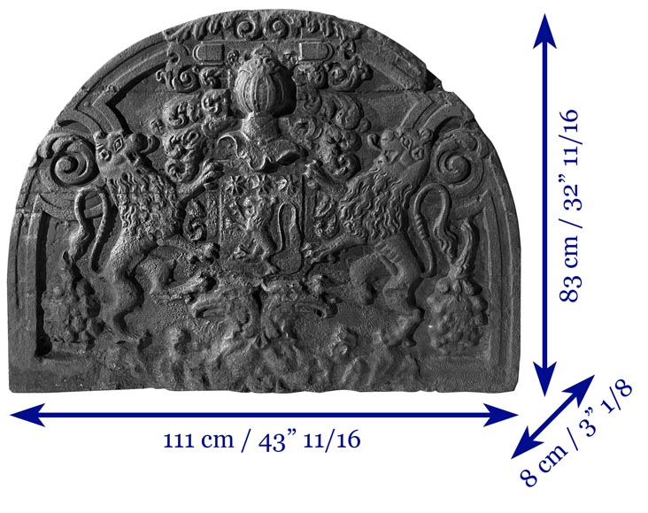 A semicircular cast iron fireplace plaque, decorated with a coat of arms, surmounted by a helmet and framed by lions. A semicircular cast iron fireplace plaque, decorated with a coat of arms, surmounted by a helmet and framed by lions.-7