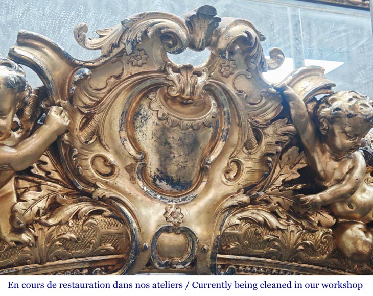 A richly gilded trumeau in the Napoleon III style, decorated with putti A richly gilded trumeau in the Napoleon III style, decorated with putti-2