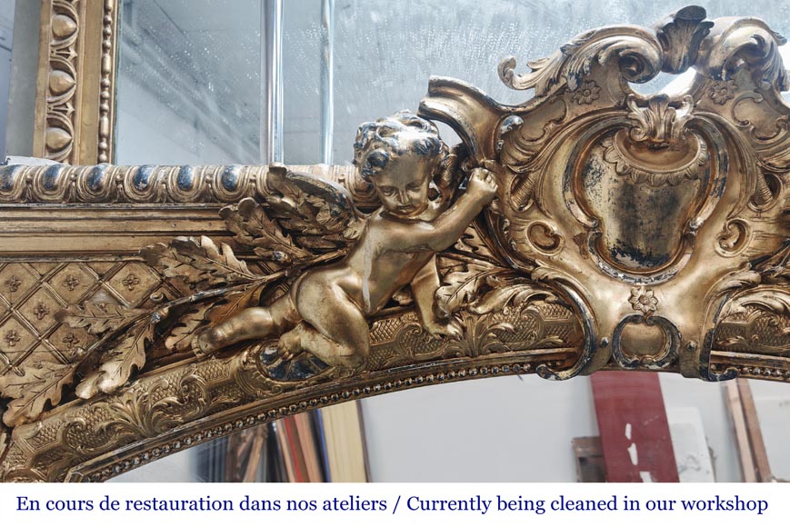 A richly gilded trumeau in the Napoleon III style, decorated with putti A richly gilded trumeau in the Napoleon III style, decorated with putti-3
