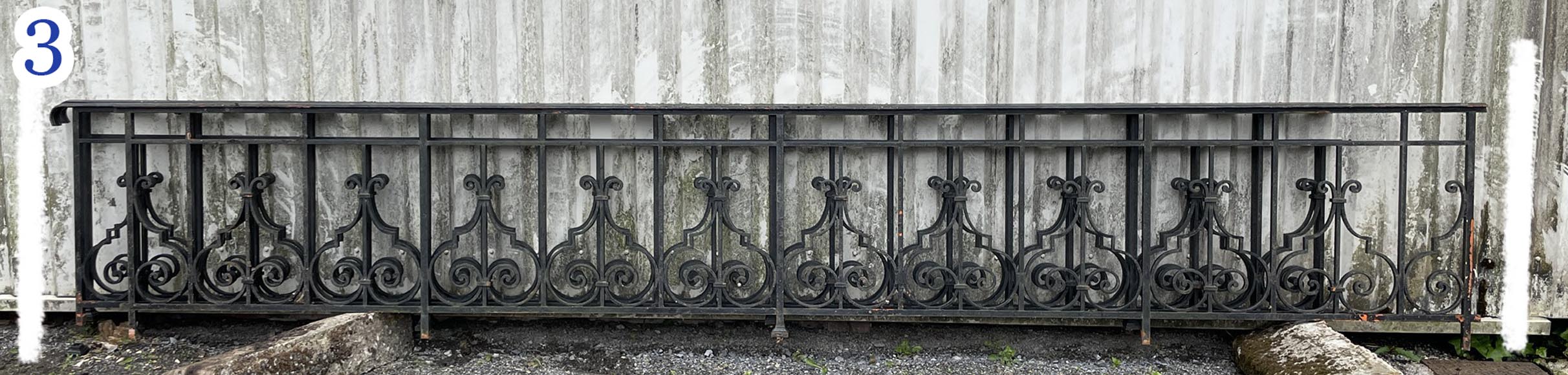 Set of wrought-iron railings featuring a design of scrolls and volute terminals, including both straight and raked sections-3