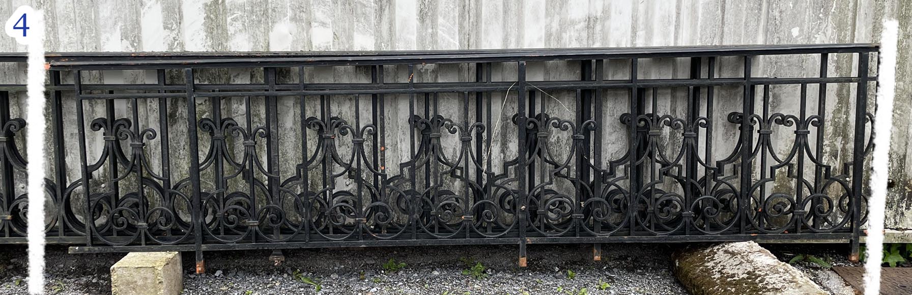 Set of wrought-iron railings featuring a design of scrolls and volute terminals, including both straight and raked sections-4