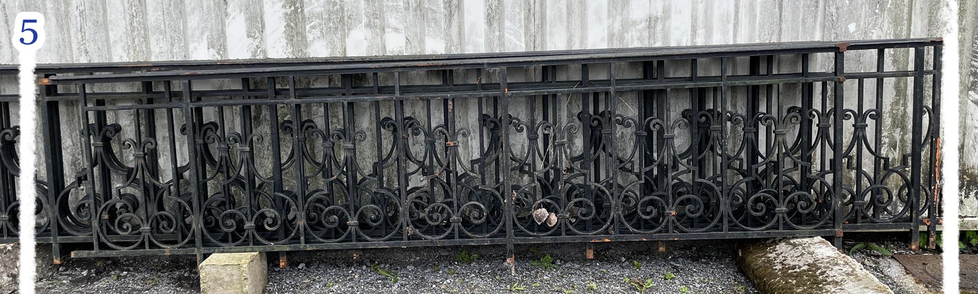 Set of wrought-iron railings featuring a design of scrolls and volute terminals, including both straight and raked sections-5
