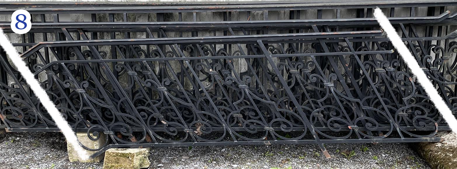 Set of wrought-iron railings featuring a design of scrolls and volute terminals, including both straight and raked sections-8
