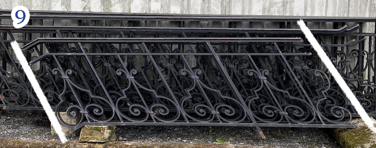 Set of wrought-iron railings featuring a design of scrolls and volute terminals, including both straight and raked sections-9