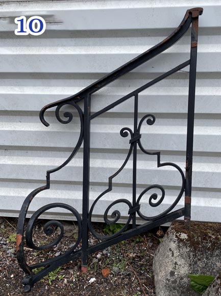 Set of wrought-iron railings featuring a design of scrolls and volute terminals, including both straight and raked sections-10