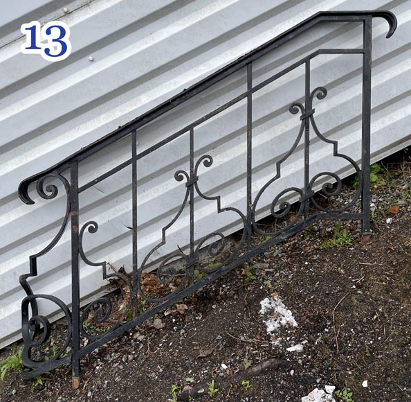 Set of wrought-iron railings featuring a design of scrolls and volute terminals, including both straight and raked sections-13