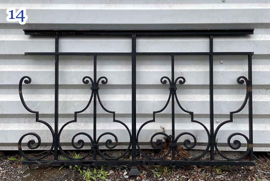 Set of wrought-iron railings featuring a design of scrolls and volute terminals, including both straight and raked sections-14