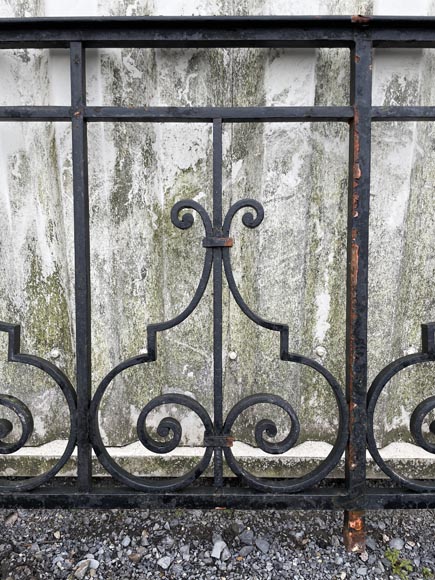 Set of wrought-iron railings featuring a design of scrolls and volute terminals, including both straight and raked sections-17