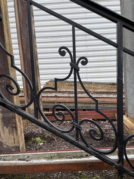 Set of wrought-iron railings featuring a design of scrolls and volute terminals, including both straight and raked sections-18