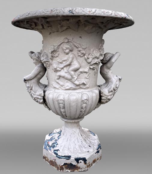 Cast iron garden vase with a frieze of cupids and handles formed as winged putti Cast iron garden vase with a frieze of cupids and handles formed as winged putti-0