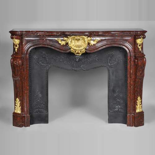 Very beautiful antique Louis XV style fireplace made out of Red Griotte marble with gilded bronze ornaments
