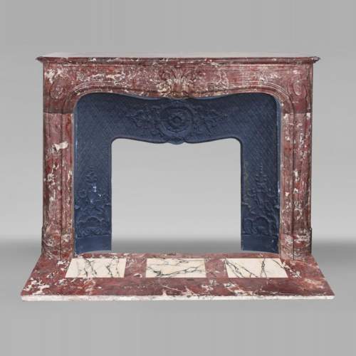 Louis XV-style fireplace decorated with a palmette, carved from peach-blossom marble