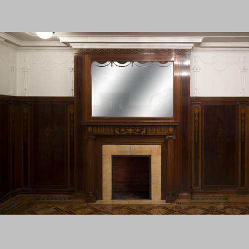 Exceptional antique Regency style complete paneled room in mahogany marquetry with fireplace, France 19th century