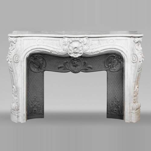 Louis XV style fireplace in Carrara marble, richly decorated with shells and flowers