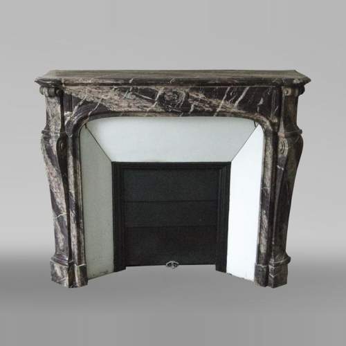 An antique Louis Xv style fireplace, Pompadour model, made out of Campan rubané marble