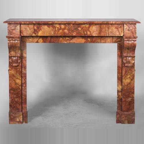 An antique Napoléon III style fireplace, made out of Breche Sanguine marble, with "modillons"