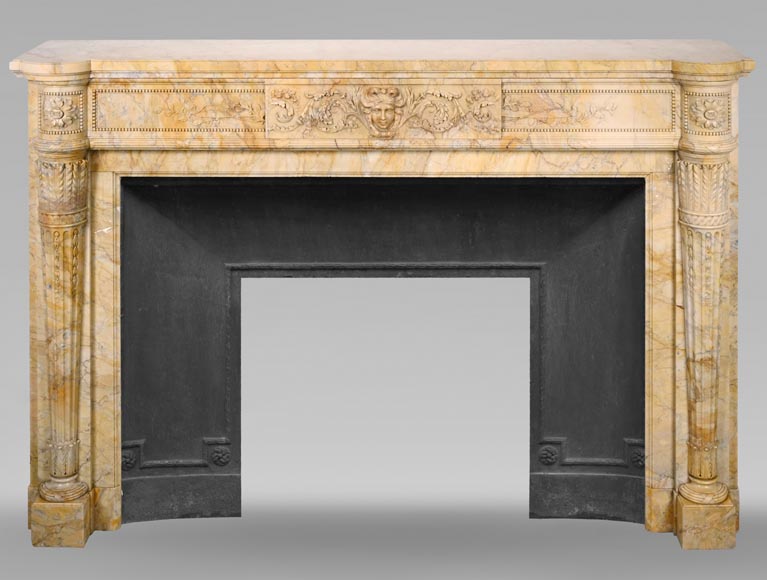 Large Louis XVI style mantel in yellow Sienna marble with entablature adorned with the head of Apollo and arrow heads on the jambs-0