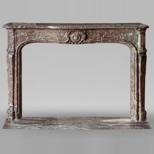 Louis XV period mantel in Rouge Royal marble
