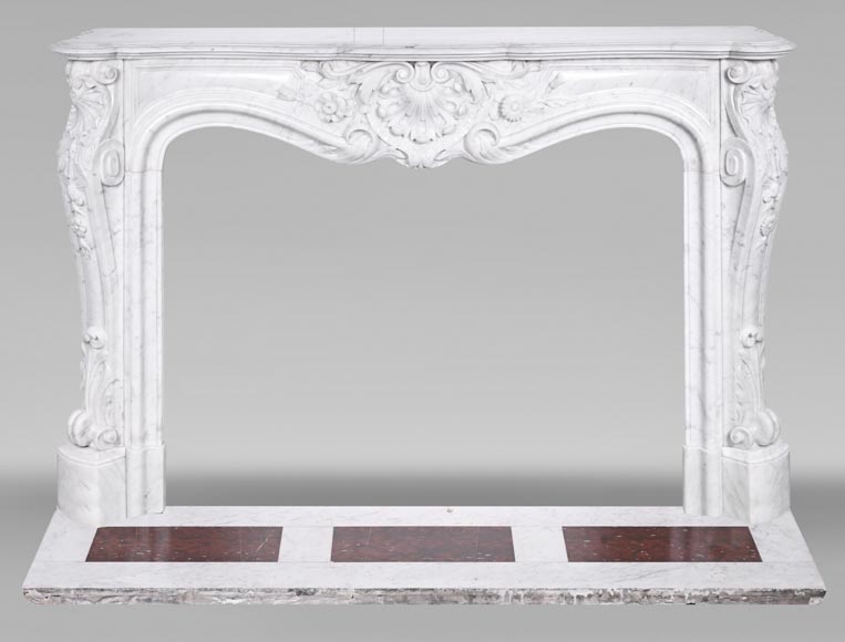 A highly sculpted Louis XV style fireplace in Carrara marble, decorated with a shell motif.-0
