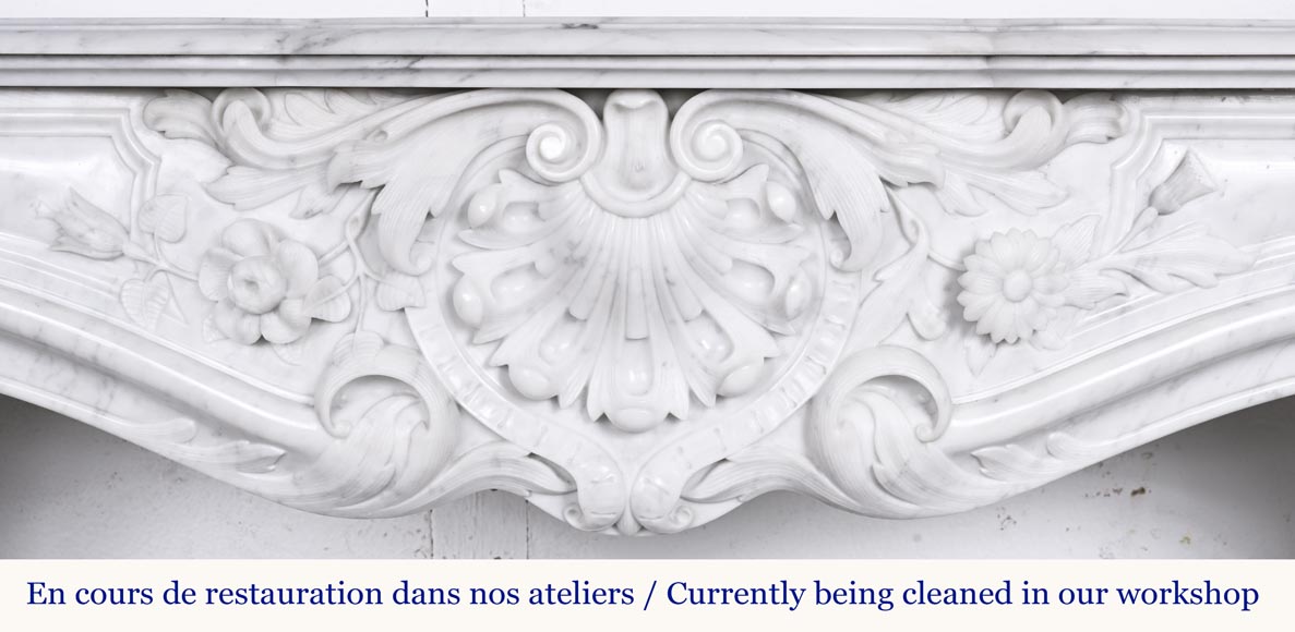 A highly sculpted Louis XV style fireplace in Carrara marble, decorated with a shell motif.-1