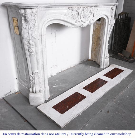 A highly sculpted Louis XV style fireplace in Carrara marble, decorated with a shell motif.-6