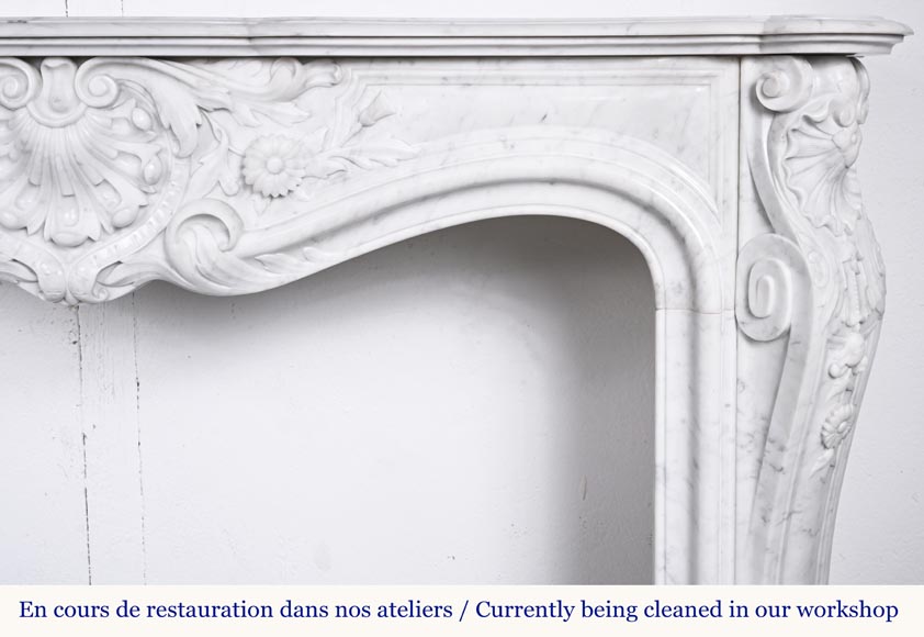 A highly sculpted Louis XV style fireplace in Carrara marble, decorated with a shell motif.-11