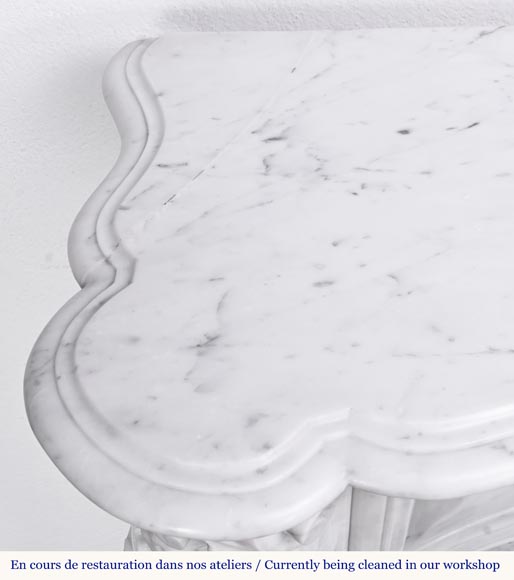 A highly sculpted Louis XV style fireplace in Carrara marble, decorated with a shell motif.-16