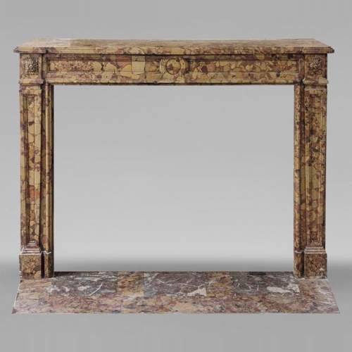 Louis XVI period mantel adorned with a rose window carved in Aleppo Breche