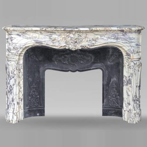 Large Regency-style mantel richly carved in violet breche marble