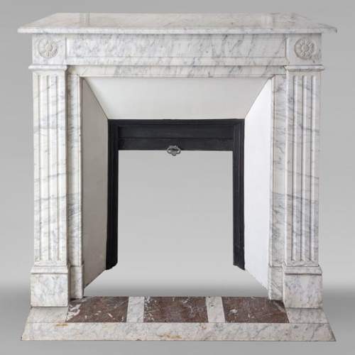 Louis XVI style mantel in veined Carrara marble with flower adorned heads