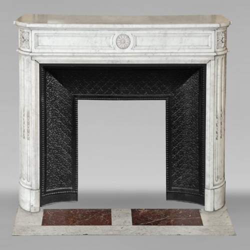Louis XVI style Carrara marble mantel with rounded corners adorned with a sunflower flower