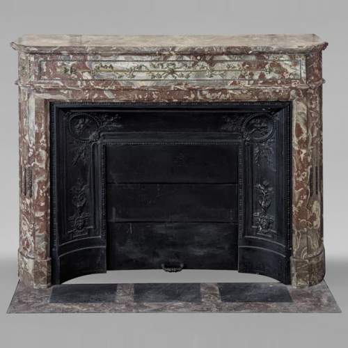 Louis XVI style mantel with rounded corners and bronze ornaments