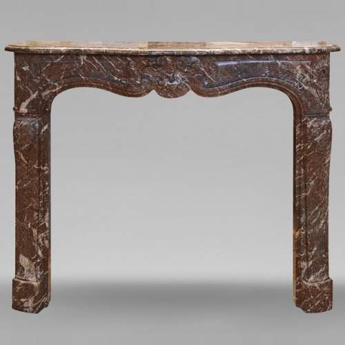 Louis XV style mantel in Rouge Royal marble with asymmetrical shell motif