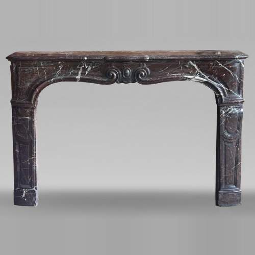 Louis XV period fireplace with molded entablature, in Campan marble