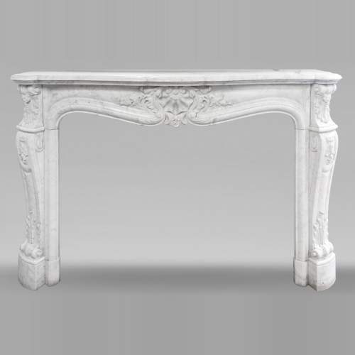Richly carved Louis XV style fireplace in Carrara marble
