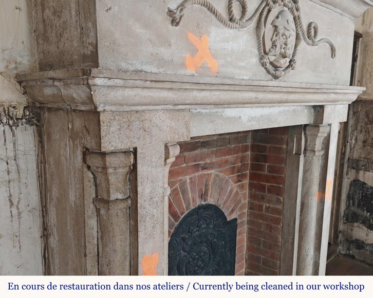 Carved stone fireplace with three-faced mask decoration-2