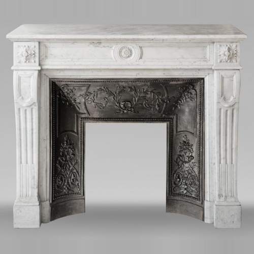 Louis XVI style fireplace in Carrara marble, decorated with a flower